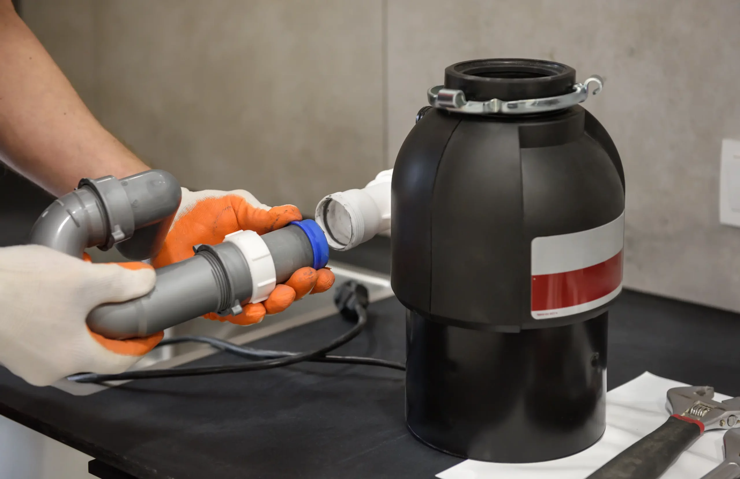 Technician repairing a residential garbage disposal