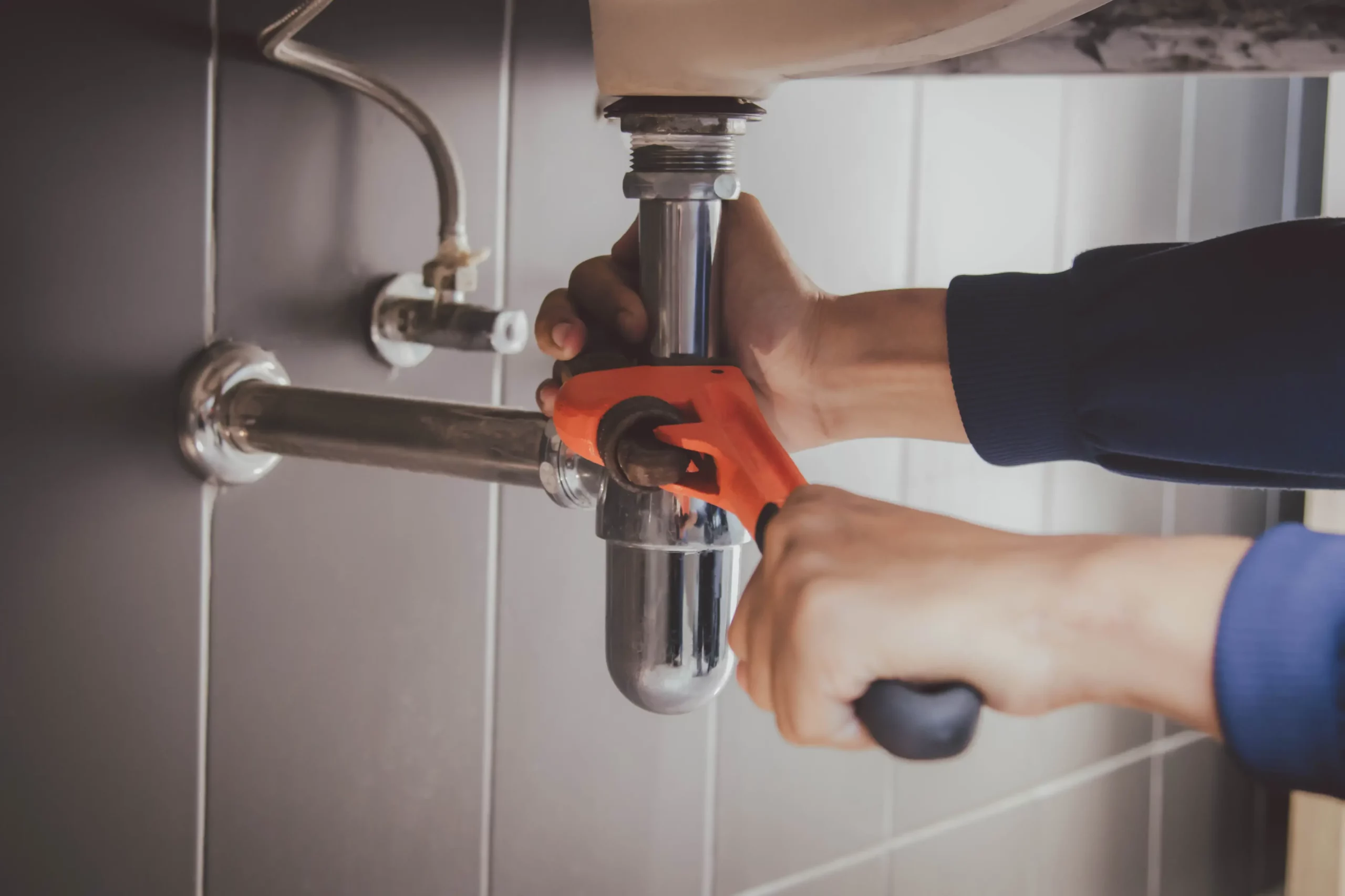 Plumber replacing water pipes in a residential home