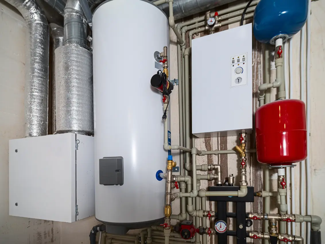 Water heater tank inspected for signs of leaking or corrosion